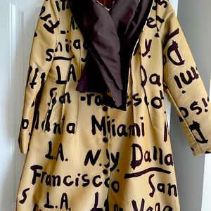 Tan and brown coat with names Vegas, New York, LA, Dallas, San Francisco, on.